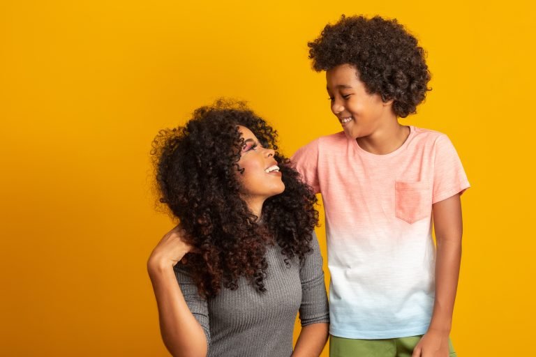 Portrait of young African American mother with toddler son. Yell